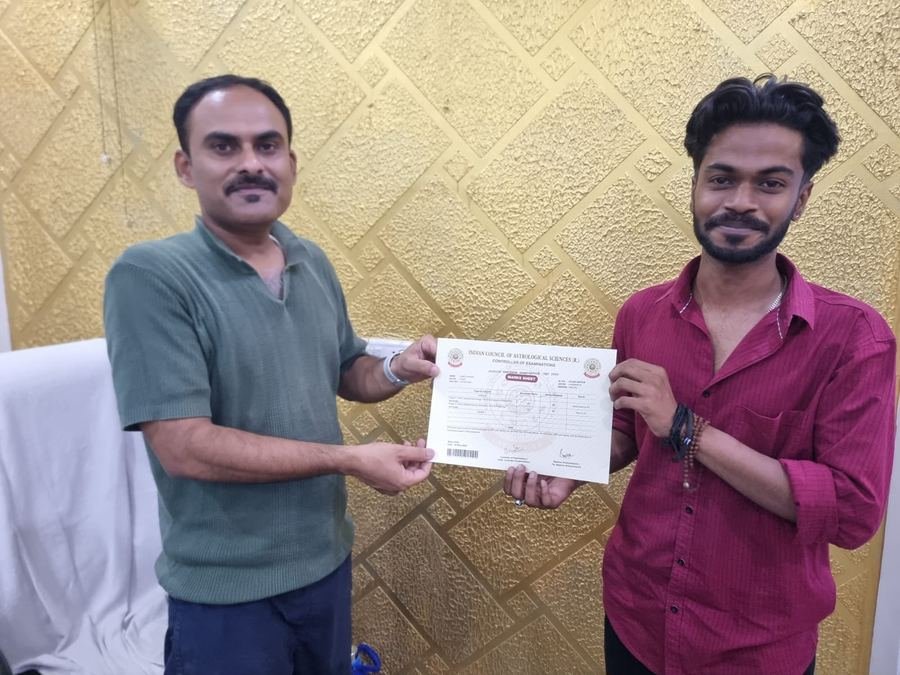 A graduate holding their ICAS marks sheet