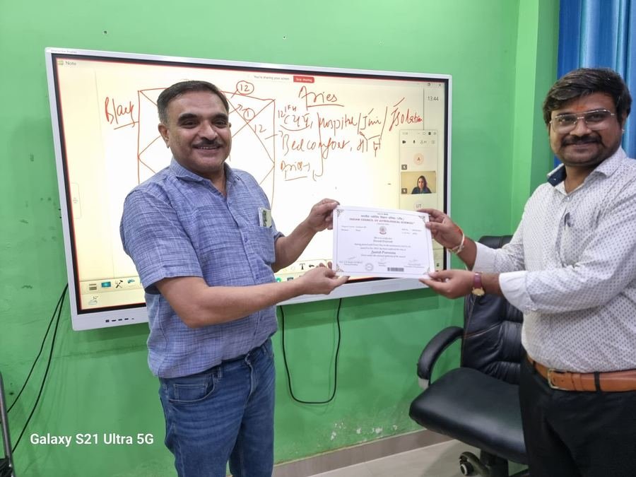 A Jyotish Praveena certificate being presented to a student